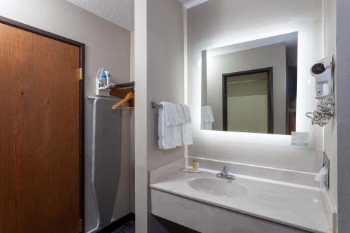 a bathroom with a sink and a mirror at Days Inn by Wyndham Wooster in Wooster