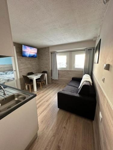a living room with a couch and a table at BELLAVISTA APARTMENT in Passo del Tonale
