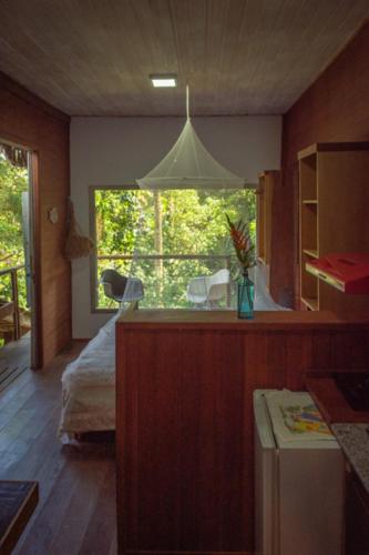 a bedroom with a bed and a large window at Casa Grande Flats in Abraão