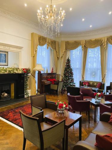 a living room with a christmas tree and a fireplace at Ravna Gora in London