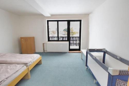 a hospital room with two beds and a window at Jestřebí chalupa in Rtyně v Podkrkonoší