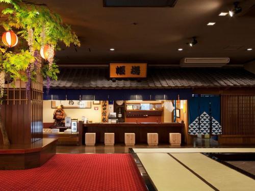 a restaurant with a table and chairs in a room at Shima Yamaguchikan in Nakanojo