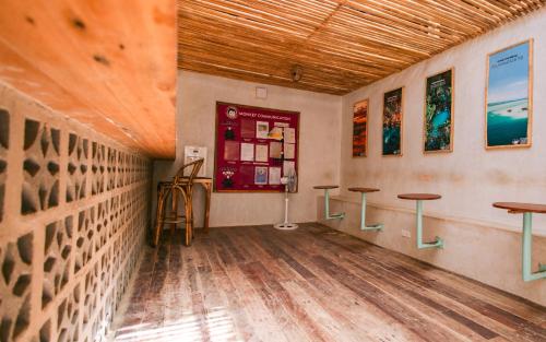 a room with two tables and a counter at Mad Monkey Hostel Nacpan Beach in El Nido