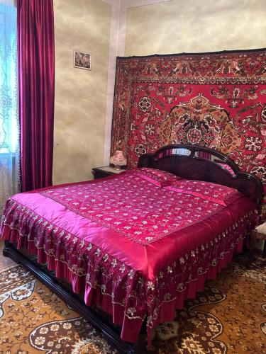 a bedroom with a bed with a red bedspread at Apartment in Tsaghkadzor