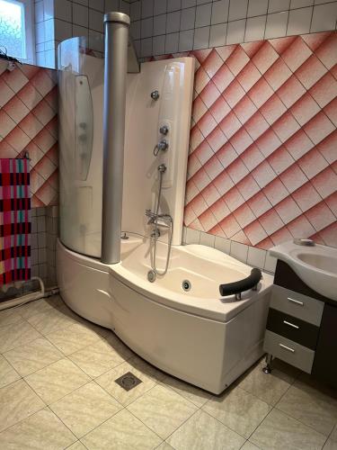 a bath tub in a bathroom with a sink at Apartment in Tsaghkadzor