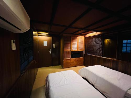 a bedroom with two beds and a window at I Villa in in Kuala Lumpur