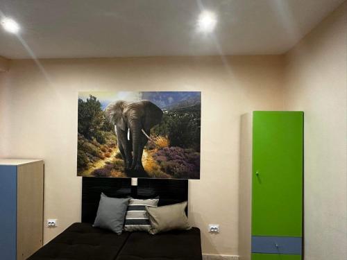 a painting of an elephant hanging on a wall at Апартамент Миели in Sofia
