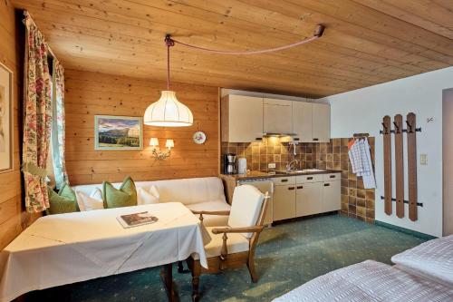 a living room with a table and a kitchen at Appartementhaus Holiday in Lech am Arlberg