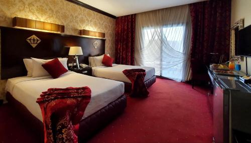 a hotel room with two beds and a window at Jewel Sport City and Aqua Park in Cairo