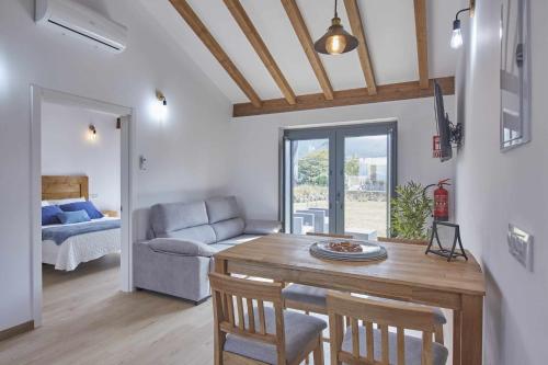 a living room with a table and a couch at Apartamentos Turísticos A Galera Ribadeo in Ribadeo