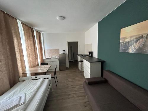 Cette chambre comprend un lit, une table et un bureau. dans l'établissement SkyApartment#101, à Francfort-sur-le-Main