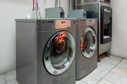two washing machines and a dryer in a room at Days Inn by Wyndham Wooster in Wooster