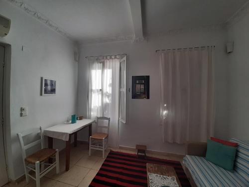 a living room with a desk and a table at Garden of Chios - Mosaic in Chios