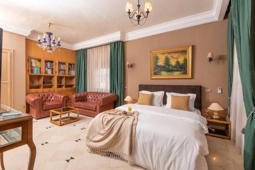 a bedroom with a bed and a living room at Riad Raja in La Soukra