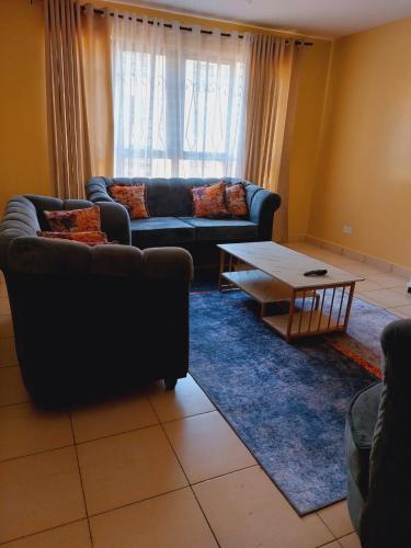 a living room with a couch and a coffee table at Solomon's Palace - Nairobi in Nairobi