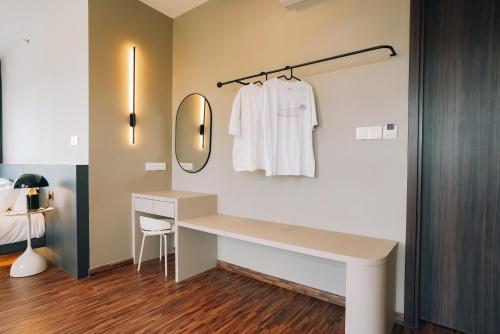 a dressing room with a dressing table and a mirror at K Avenue The Pillow House, 5 Minutes from KKIA in Penampang