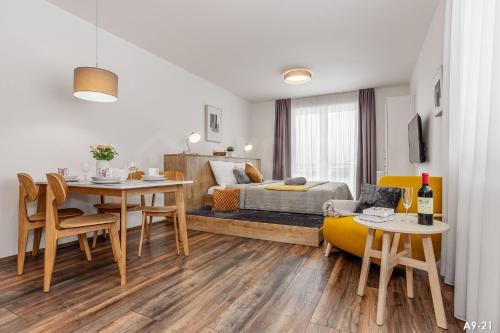 a living room with a dining table and a bedroom at KORZO LIPNO 2 in Lipno nad Vltavou