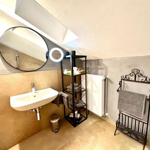 a bathroom with a sink and a mirror at Ferienappartment Zürker in Garmisch-Partenkirchen