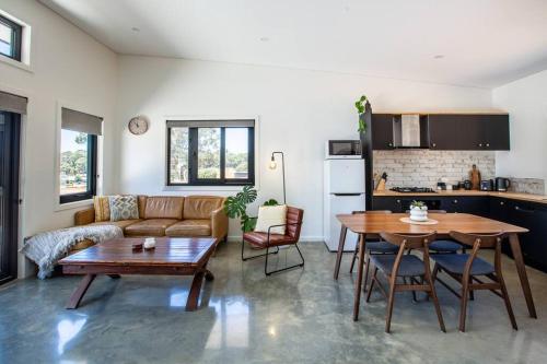 una sala de estar con un sofá y una mesa en Flame Tree Retreat, en Margaret River Town