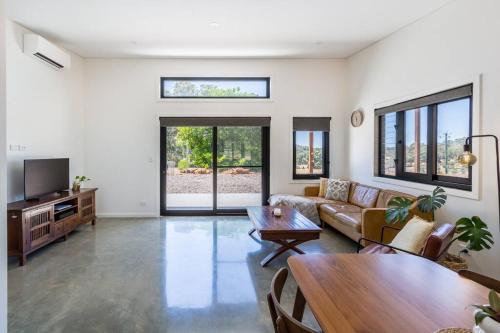 a living room with a couch and a table at Flame Tree Retreat in Margaret River Town