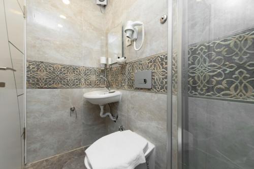 a bathroom with a toilet and a sink and a shower at OLD iSTANBUL HOUSE HOTEL in Istanbul