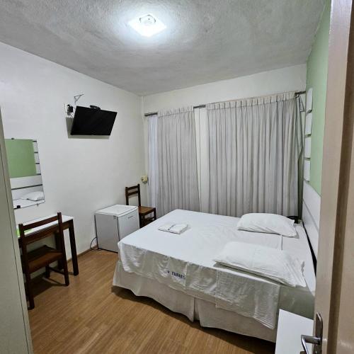Ένα ή περισσότερα κρεβάτια σε δωμάτιο στο Hotel Turista