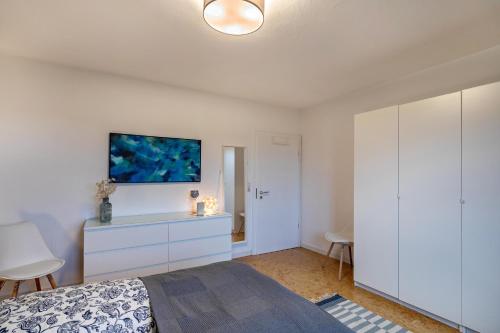 a bedroom with a bed and a tv on the wall at Apartement Hangarstein in Kassel