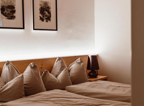a bed with white pillows in a bedroom at ALPINE LOFT Martini in Annaberg im Lammertal