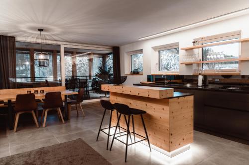 a kitchen and dining room with a table and chairs at ALPINE LOFT Martini in Annaberg im Lammertal