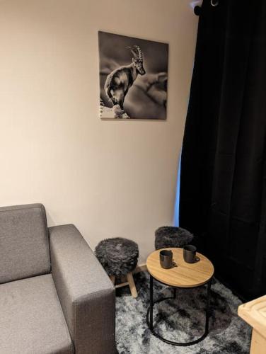 a living room with a couch and a table at Superbe appartement sur le front de neige in Val Thorens