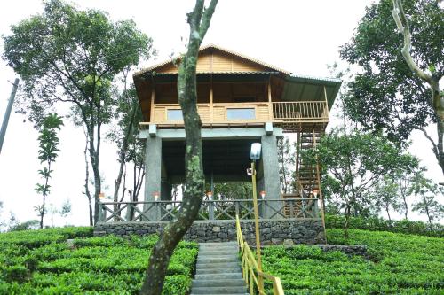a house on a hill with stairs leading to it at Holiday Vagamon in Vagamon