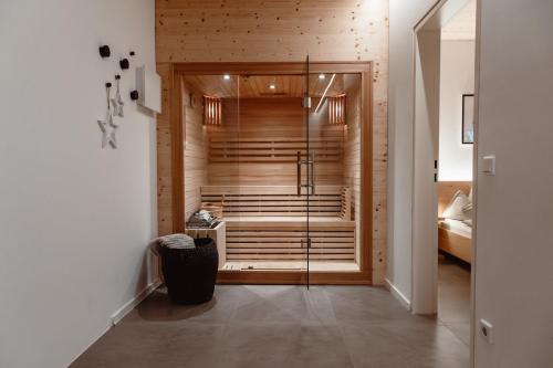 a walk in shower in a room with a bedroom at ALPINE LOFT Martini in Annaberg im Lammertal