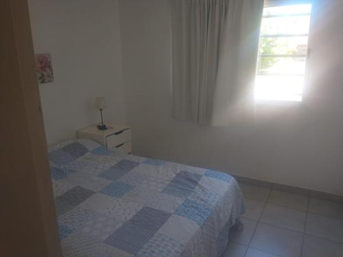 a small bedroom with a bed and a window at Los alamos in Chascomús