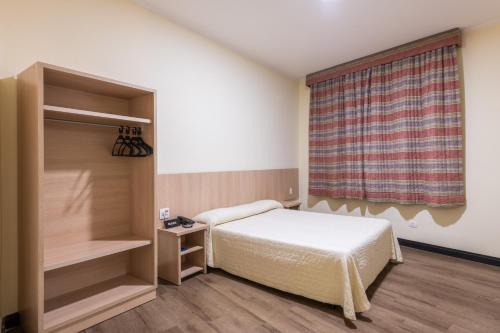 a small bedroom with a bed and a window at DELPLAZA Timbiras São Paulo in Sao Paulo