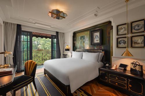 Ένα ή περισσότερα κρεβάτια σε δωμάτιο στο Capella Hanoi