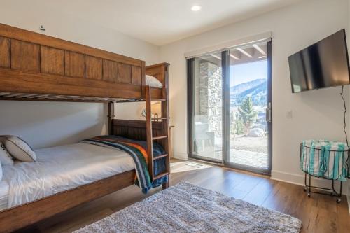 a bedroom with a bunk bed and a large window at Creekhouse 1364 in Mammoth Lakes