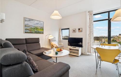 a living room with a couch and a table at Fanø Bad, Lejl 74 in Fanø