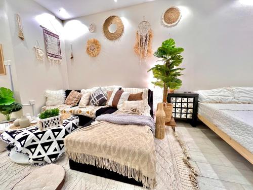 a living room with a couch and a bed at Boho lovely - بتسجيل وصول ذاتي in Riyadh