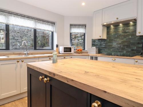 a large kitchen with a wooden counter top at Garth Hill House in Ambleside