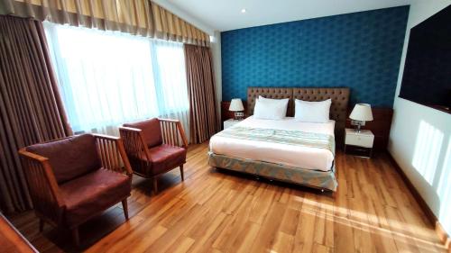 a hotel room with a bed and two chairs at Old Port Hotel in Istanbul