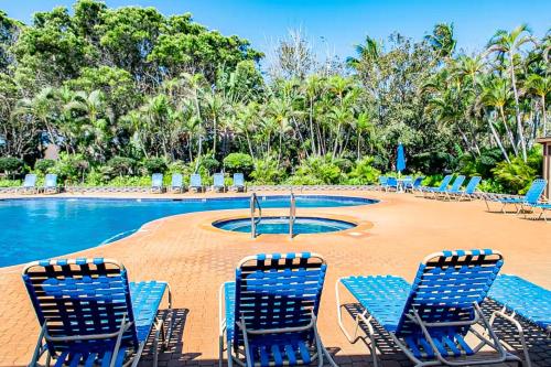 a group of chairs sitting around a swimming pool at Ke Nani Kai in Maunaloa