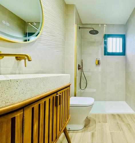 a bathroom with a sink and a toilet and a shower at Canaryislandshost l Beach in Puerto del Carmen