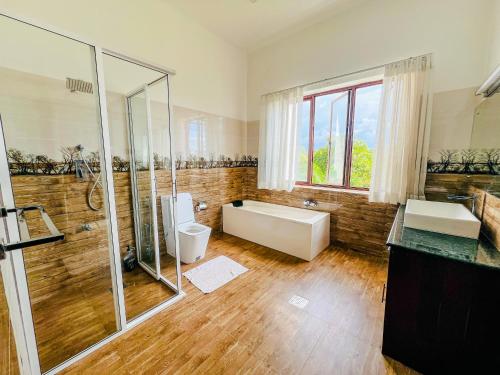 a bathroom with two sinks and a tub and a shower at Countryside Villa 