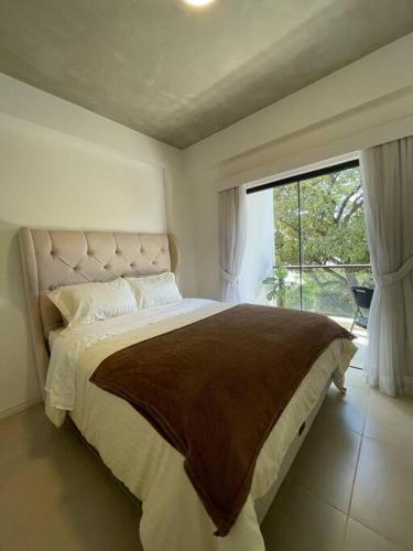 a bedroom with a large bed and a large window at Luxury Experience in Asunción: Fully Equipped in Asunción