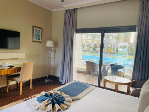 a hotel room with a bed and a view of a pool at Jewel Sport City and Aqua Park in Cairo