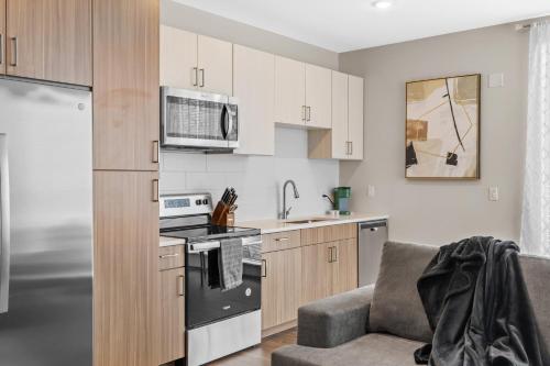a kitchen with a couch and a stove top oven at The Rodeo Drive Suite Penthouse The Gulch in Nashville
