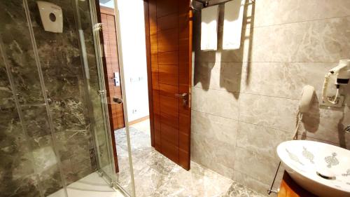 a bathroom with a shower and a sink at Old Port Hotel in Istanbul