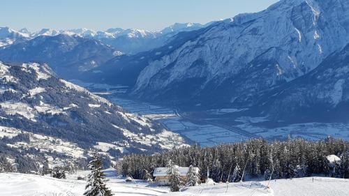 a view of a snow covered mountains with a valley at Ferienwohnung Dolomitenpanorama in Oberlienz