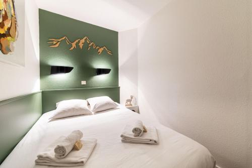 Ένα ή περισσότερα κρεβάτια σε δωμάτιο στο La Fruitiere - IMMODREAMS - Avoriaz