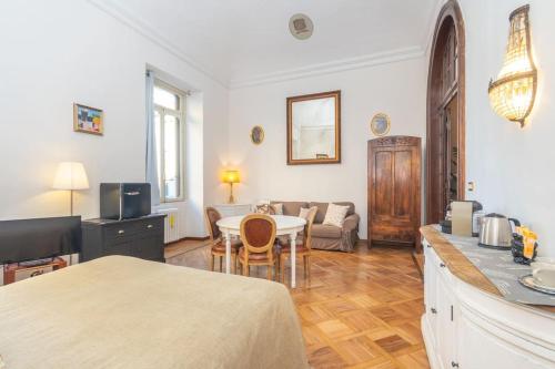 a living room with a table and a couch at Liberty Suite in Turin
